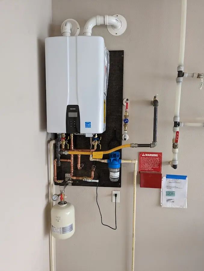 Professional plumber installing copper piping in a Heavener home